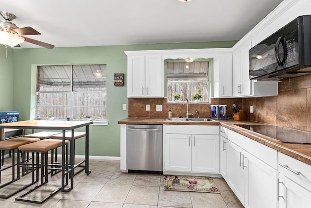 1135 Brandywine St, Beaumont, TX 77706 - kitchen with black appliances, backsplash, a ceiling fan, and white cabinets