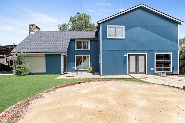 1135 Brandywine St, Beaumont, TX 77706 - back of house featuring a shingled roof, a yard, a chimney, french doors, and a patio