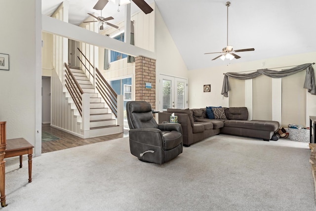 1135 Brandywine St, Beaumont, TX 77706 - living area featuring ceiling fan, high vaulted ceiling, stairs, and carpet flooring