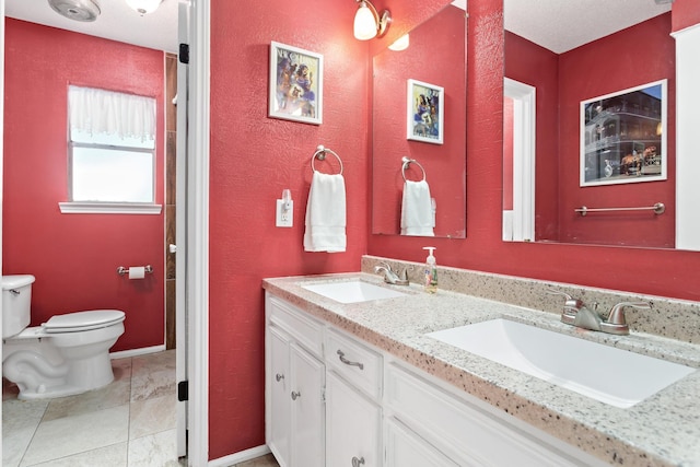 1135 Brandywine St, Beaumont, TX 77706 - full bathroom with double vanity and a textured wall
