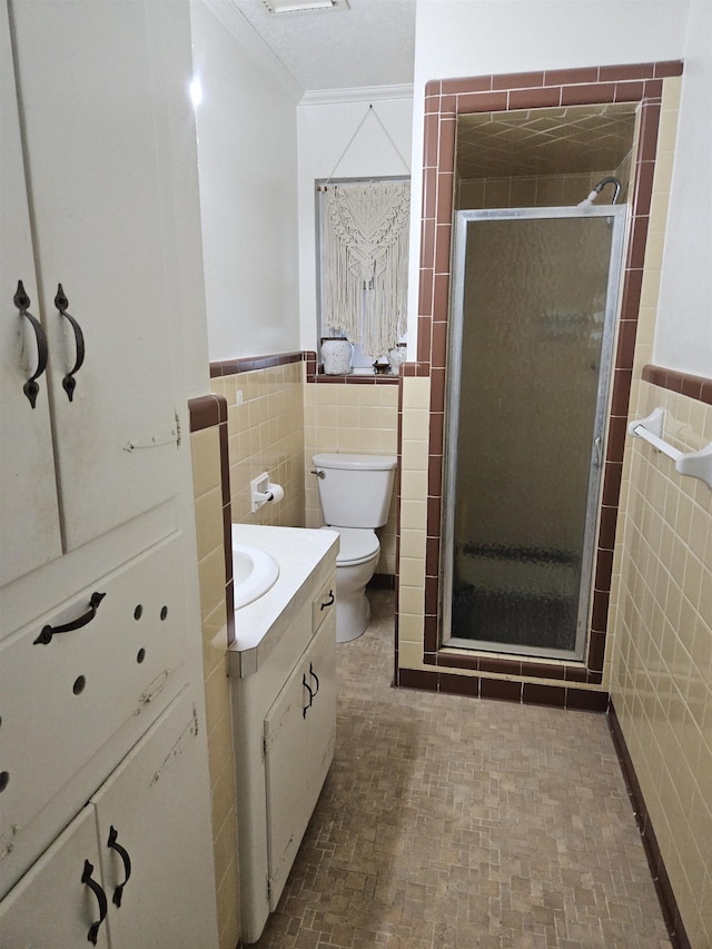 bathroom with walk in shower, vanity, toilet, and tile walls