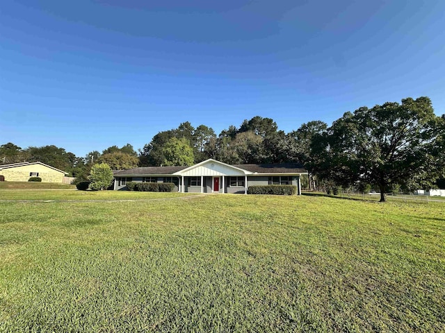 ranch-style house featuring a carport and a front lawn
