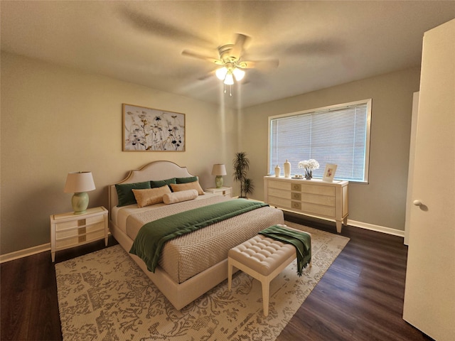 bedroom with ceiling fan, wood finished floors, and baseboards