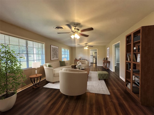 living area featuring baseboards, visible vents, ceiling fan, and dark wood-type flooring