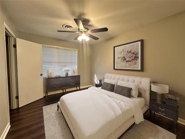 bedroom featuring visible vents, dark wood-type flooring, a ceiling fan, and baseboards