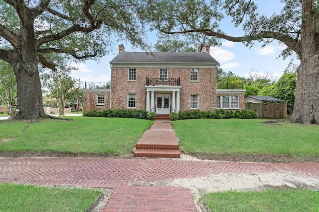 colonial-style house with a front yard