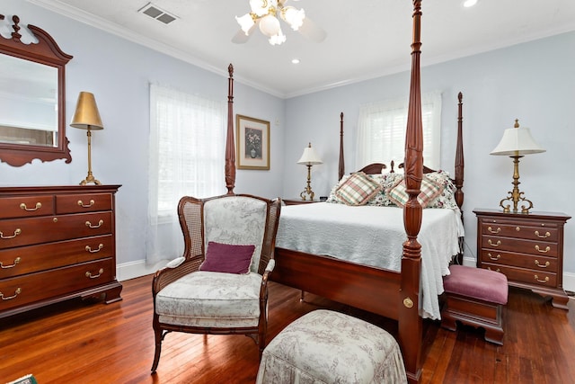 bedroom featuring multiple windows, dark hardwood / wood-style flooring, ceiling fan, and ornamental molding