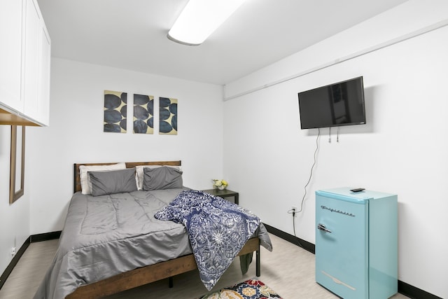 bedroom featuring fridge