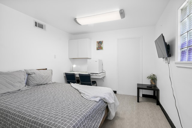 bedroom featuring light carpet