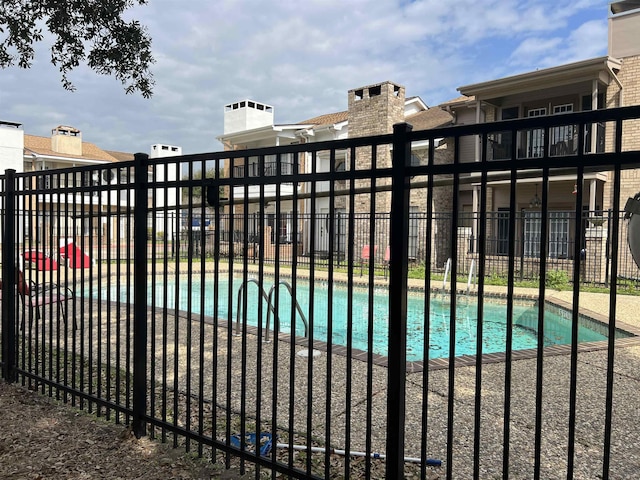 view of gate with a community pool