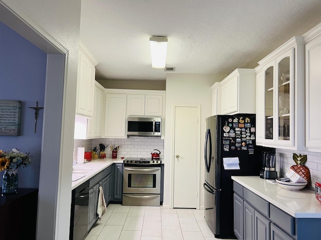 kitchen featuring white cabinets and appliances with stainless steel finishes