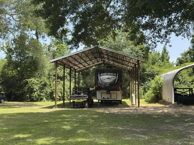15590 S Fm 92, Spurger, TX 77660 - view of home's community with a carport, a lawn, and dirt driveway