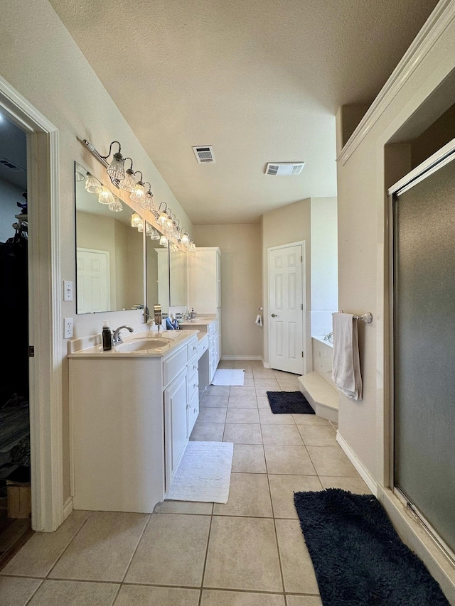 15590 S Fm 92, Spurger, TX 77660 - full bathroom with double vanity, tile patterned floors, a stall shower, and a bath