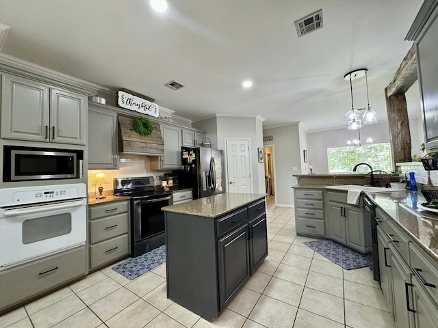 15590 S Fm 92, Spurger, TX 77660 - kitchen with electric range, white oven, refrigerator with ice dispenser, stainless steel microwave, and premium range hood