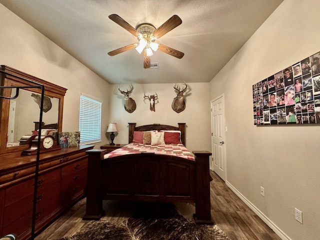 15590 S Fm 92, Spurger, TX 77660 - bedroom with dark wood-style flooring and ceiling fan