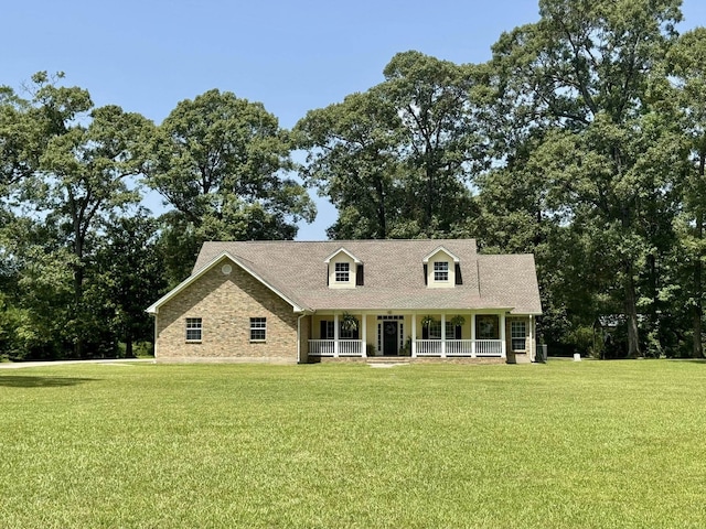 15590 S Fm 92, Spurger, TX 77660 - cape cod-style house with covered porch and a front lawn
