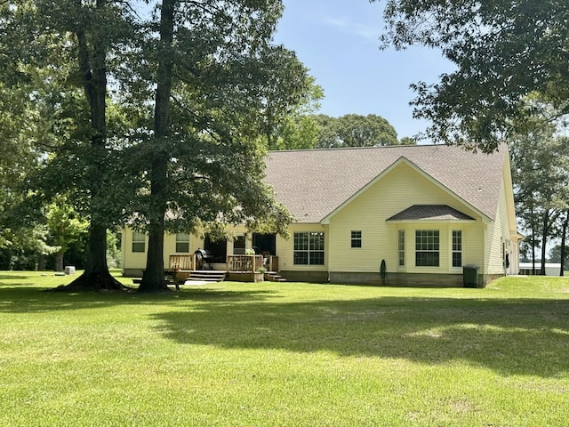 15590 S Fm 92, Spurger, TX 77660 - back of house with a deck, a lawn, and a shingled roof