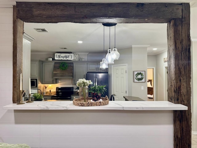 15590 S Fm 92, Spurger, TX 77660 - kitchen with stainless steel appliances, crown molding, decorative light fixtures, a peninsula, and light stone countertops