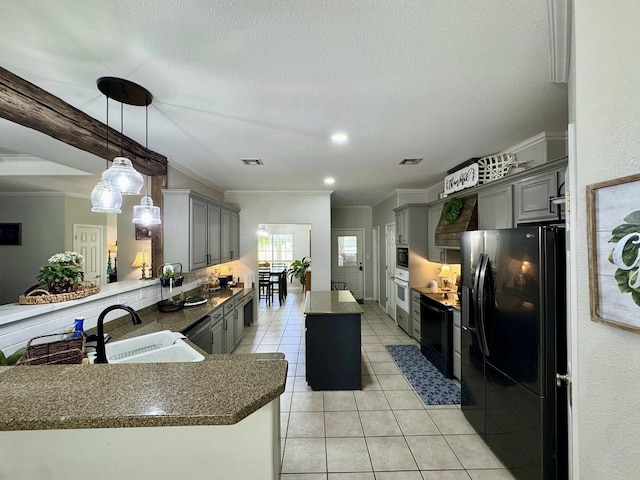 15590 S Fm 92, Spurger, TX 77660 - kitchen with black refrigerator with ice dispenser, a kitchen island, gray cabinetry, light tile patterned floors, and crown molding