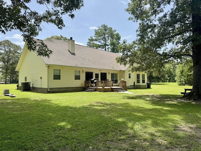 15590 S Fm 92, Spurger, TX 77660 - back of property with a chimney, a deck, a yard, and roof with shingles