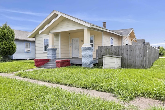 view of front of house with covered porch and a front yard