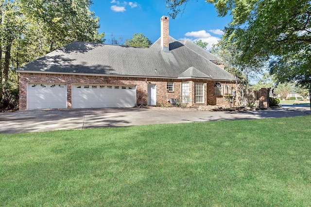 view of front of property featuring a garage and a front lawn