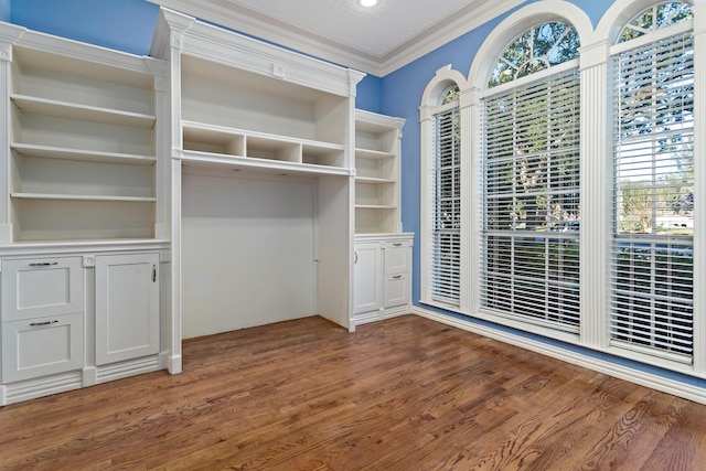 interior space with dark hardwood / wood-style flooring, a closet, and ornamental molding