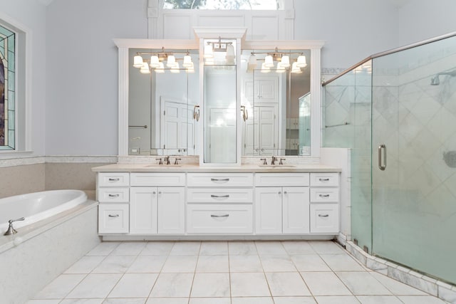 bathroom featuring tile patterned flooring, vanity, and separate shower and tub