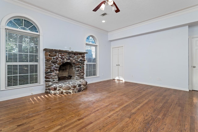 unfurnished living room featuring a fireplace, wood-type flooring, ceiling fan, and ornamental molding