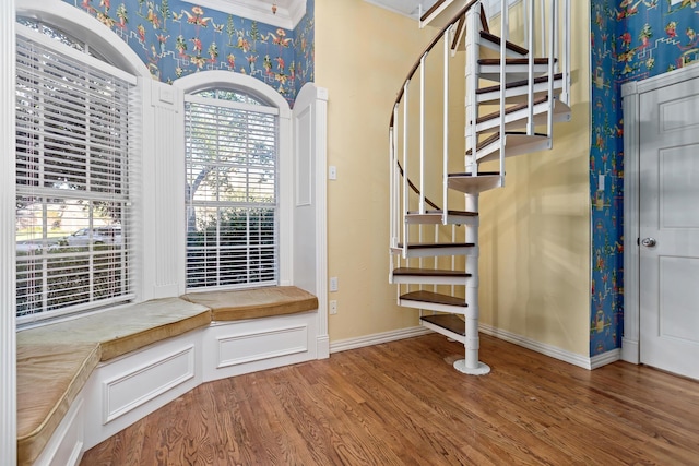 foyer featuring wood-type flooring and ornamental molding