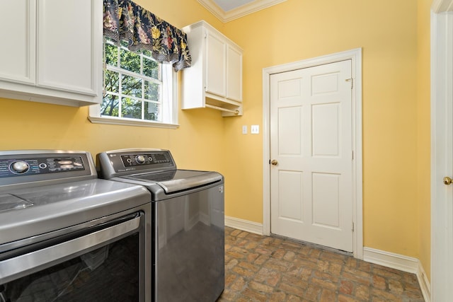 laundry room with cabinets, separate washer and dryer, and ornamental molding