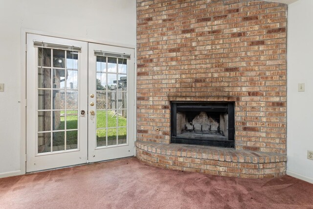 1 Cheska Holw, Beaumont, TX 77706 - unfurnished living room featuring carpet, french doors, a brick fireplace, and baseboards