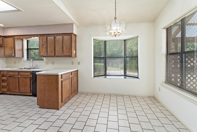 1 Cheska Holw, Beaumont, TX 77706 - kitchen with a sink, a chandelier, light countertops, pendant lighting, and brown cabinets