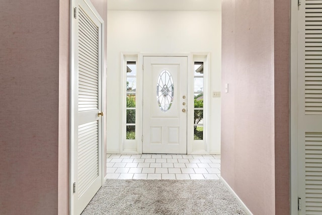 1 Cheska Holw, Beaumont, TX 77706 - foyer entrance with light carpet, light tile patterned floors, and baseboards