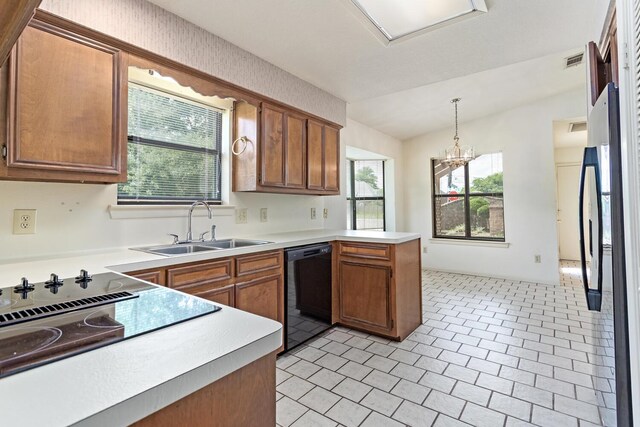 1 Cheska Holw, Beaumont, TX 77706 - kitchen with black appliances, a peninsula, a sink, light countertops, and brown cabinetry