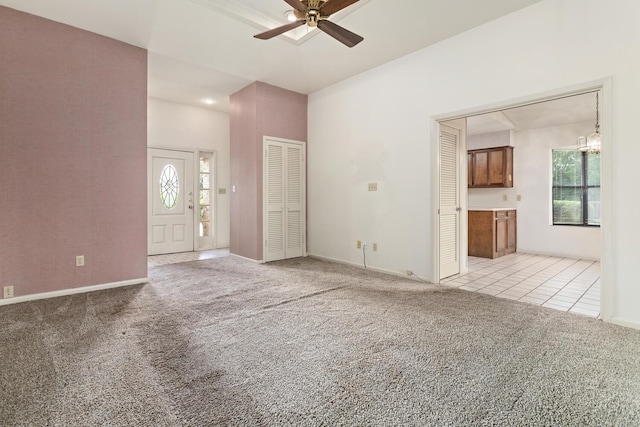 1 Cheska Holw, Beaumont, TX 77706 - unfurnished living room featuring light carpet, ceiling fan, healthy amount of natural light, and light tile patterned flooring