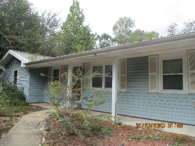 view of side of home with covered porch