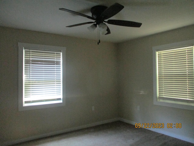 carpeted empty room featuring ceiling fan