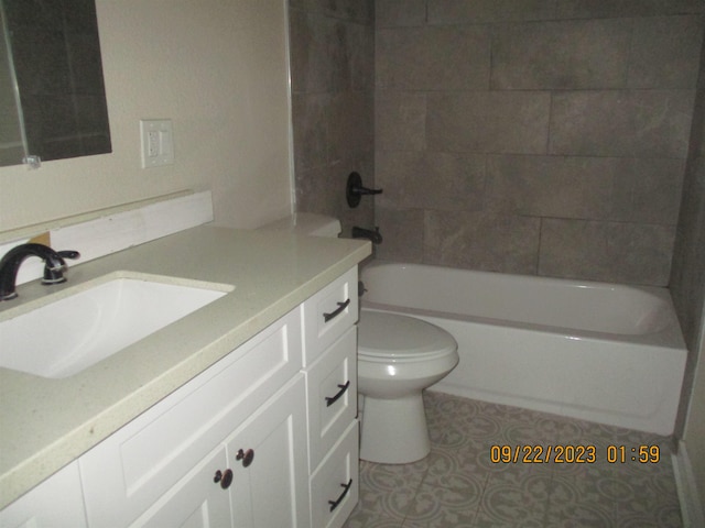 full bathroom featuring tile patterned floors, vanity, toilet, and tiled shower / bath combo