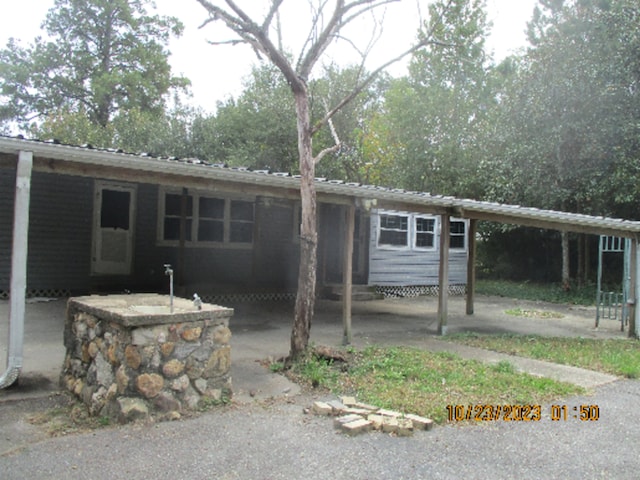 back of property featuring a carport