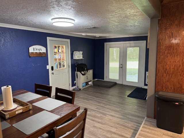 6358 Nick Ave, Port Arthur, TX 77640 - dining room with wood finished floors, french doors, a textured ceiling, ornamental molding, and baseboards