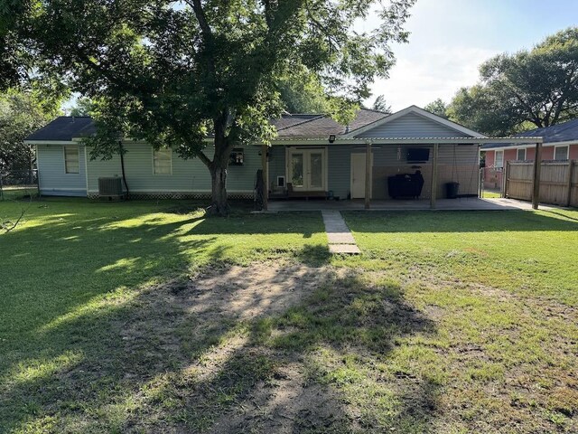 6358 Nick Ave, Port Arthur, TX 77640 - rear view of property with french doors, central AC, and a patio area