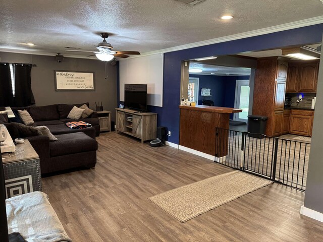 6358 Nick Ave, Port Arthur, TX 77640 - living area featuring ornamental molding, wood finished floors, a textured ceiling, ceiling fan, and baseboards
