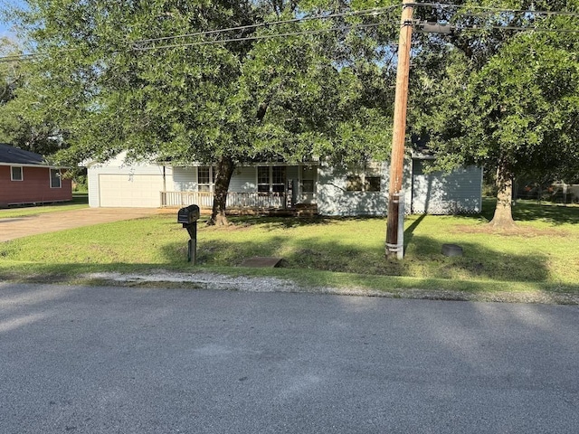 6358 Nick Ave, Port Arthur, TX 77640 - obstructed view of property featuring covered porch, concrete driveway, a front yard, and an attached garage