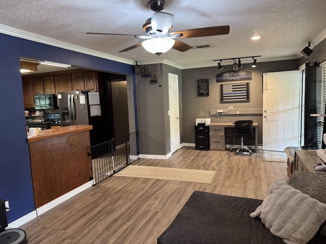 6358 Nick Ave, Port Arthur, TX 77640 - living area with a textured ceiling, light wood finished floors, a ceiling fan, crown molding, and baseboards