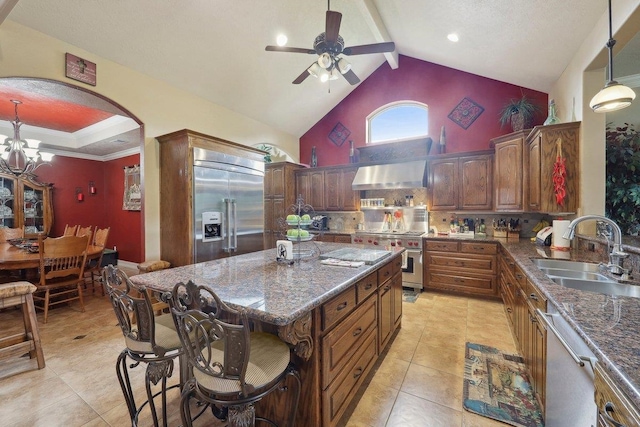 2014 Fish Lk, Kountze, TX 77625 - kitchen with wall chimney range hood, a sink, high vaulted ceiling, ceiling fan with notable chandelier, and premium appliances