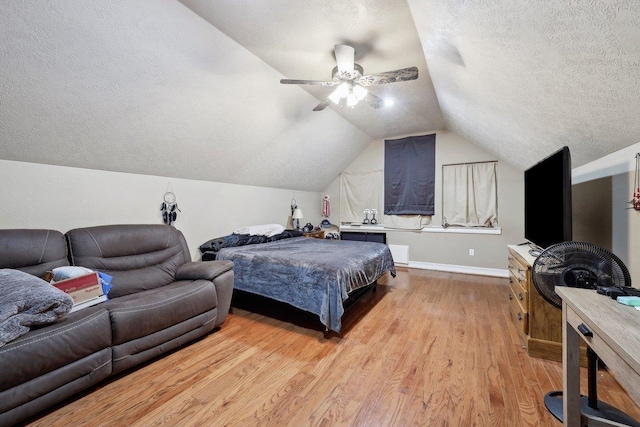 2014 Fish Lk, Kountze, TX 77625 - bedroom with baseboards, ceiling fan, a textured ceiling, light wood-style flooring, and vaulted ceiling