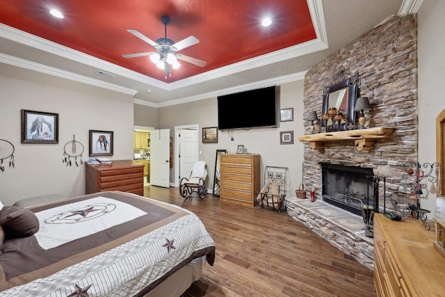 2014 Fish Lk, Kountze, TX 77625 - bedroom with a raised ceiling, ornamental molding, a stone fireplace, and wood finished floors