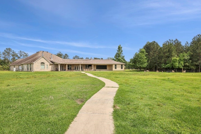 2014 Fish Lk, Kountze, TX 77625 - ranch-style house with a front lawn and fence