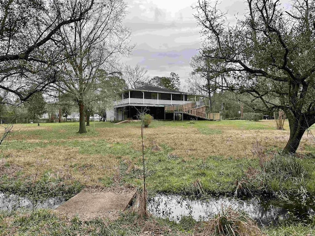 view of yard with a sunroom and a deck